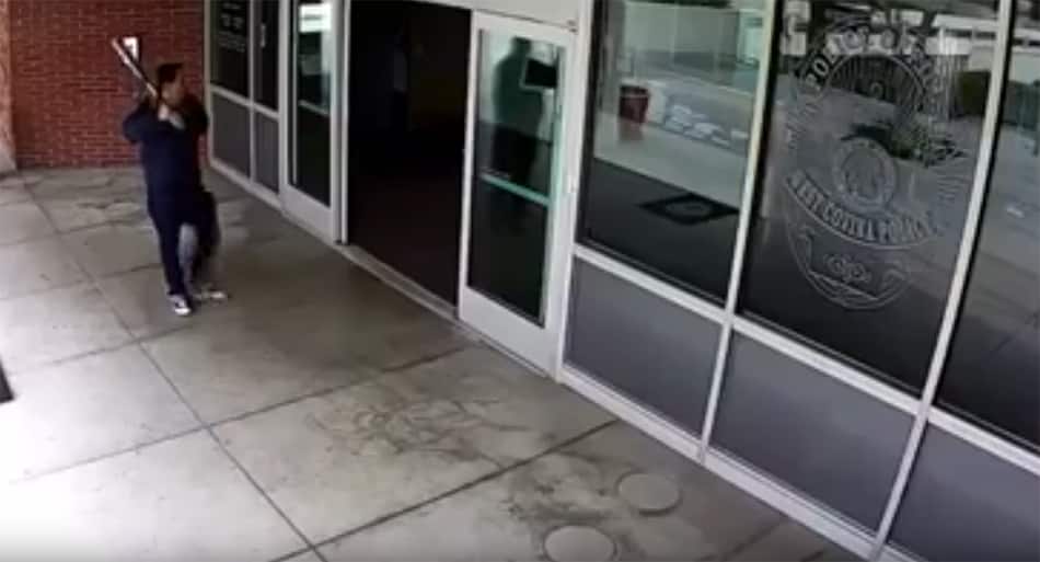 Guy threatens police station with baseball bat – does NOT go well