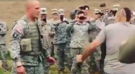 Chuck Liddell tests body armor on a soldier