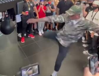 Watch: Israel Adesanya breaks punching bag arcade game with 2 kicks