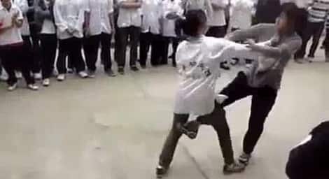Two women Kung Fu students go at it on the street