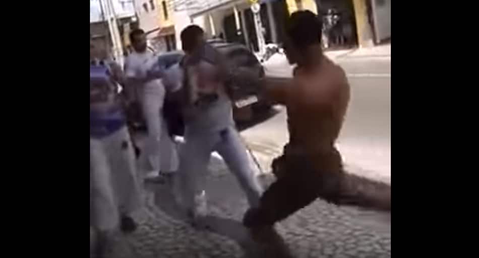 One Muay Thai fighter vs. group of Capoeira fighters on streets of Brazil