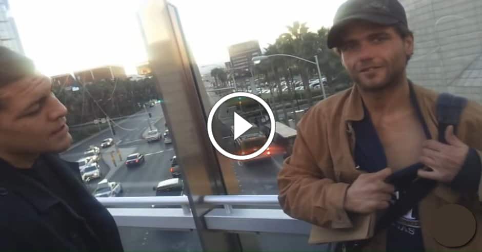 Nick Diaz gives a stack of cash to a homeless man