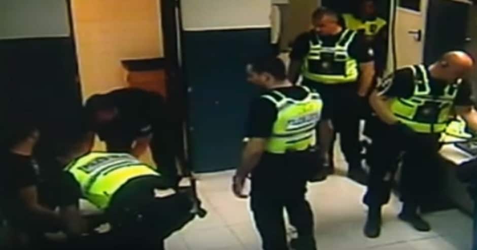 Police officer uses Karate on detainee handcuffed to a chair