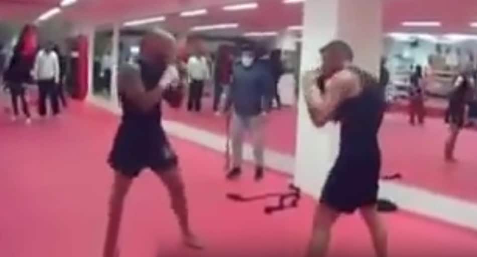 Professional kickboxer forced into gym fight by a gang of armed men