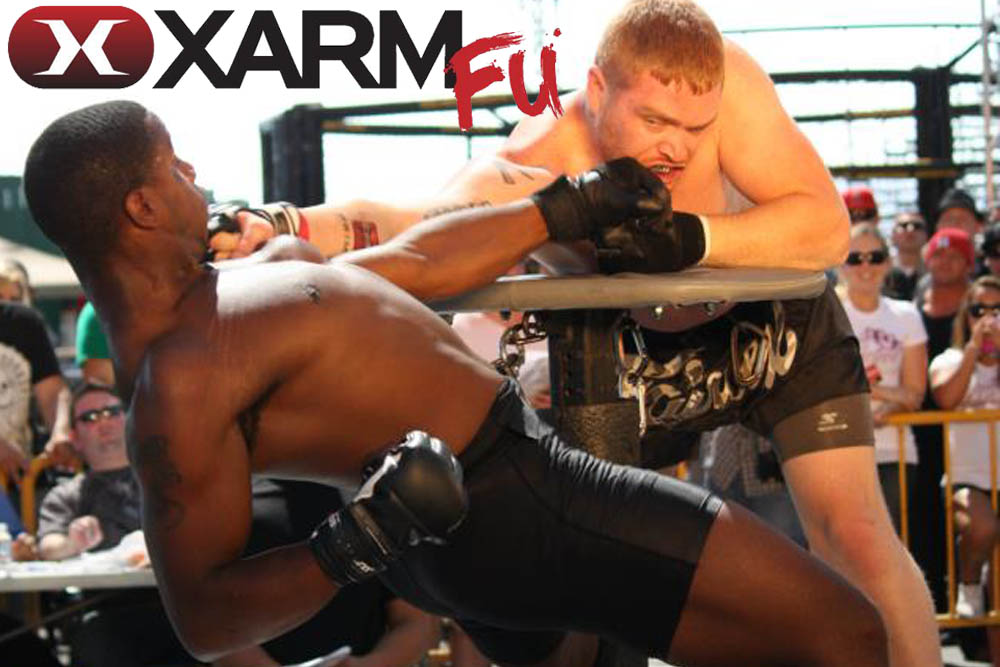MMA over a table with the fighters’ wrists tied together